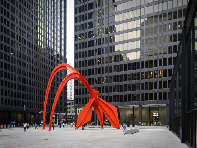 Abstract sculpture in front of International Style buildings