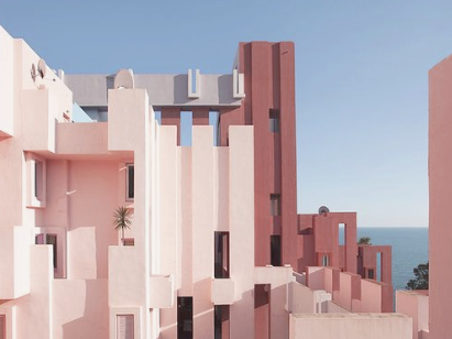 Asymmetric pink and red postmodern building towers