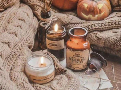 Fall setup with sweaters, candles and pumpkins