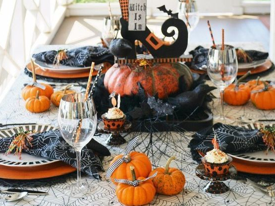 Black and orange Halloween decor on a dining table
