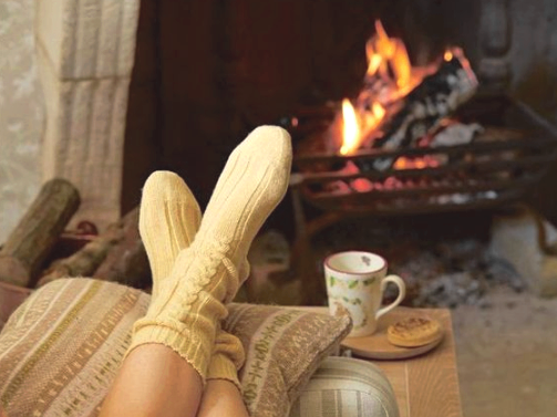Cozy socks in front of a fireplace
